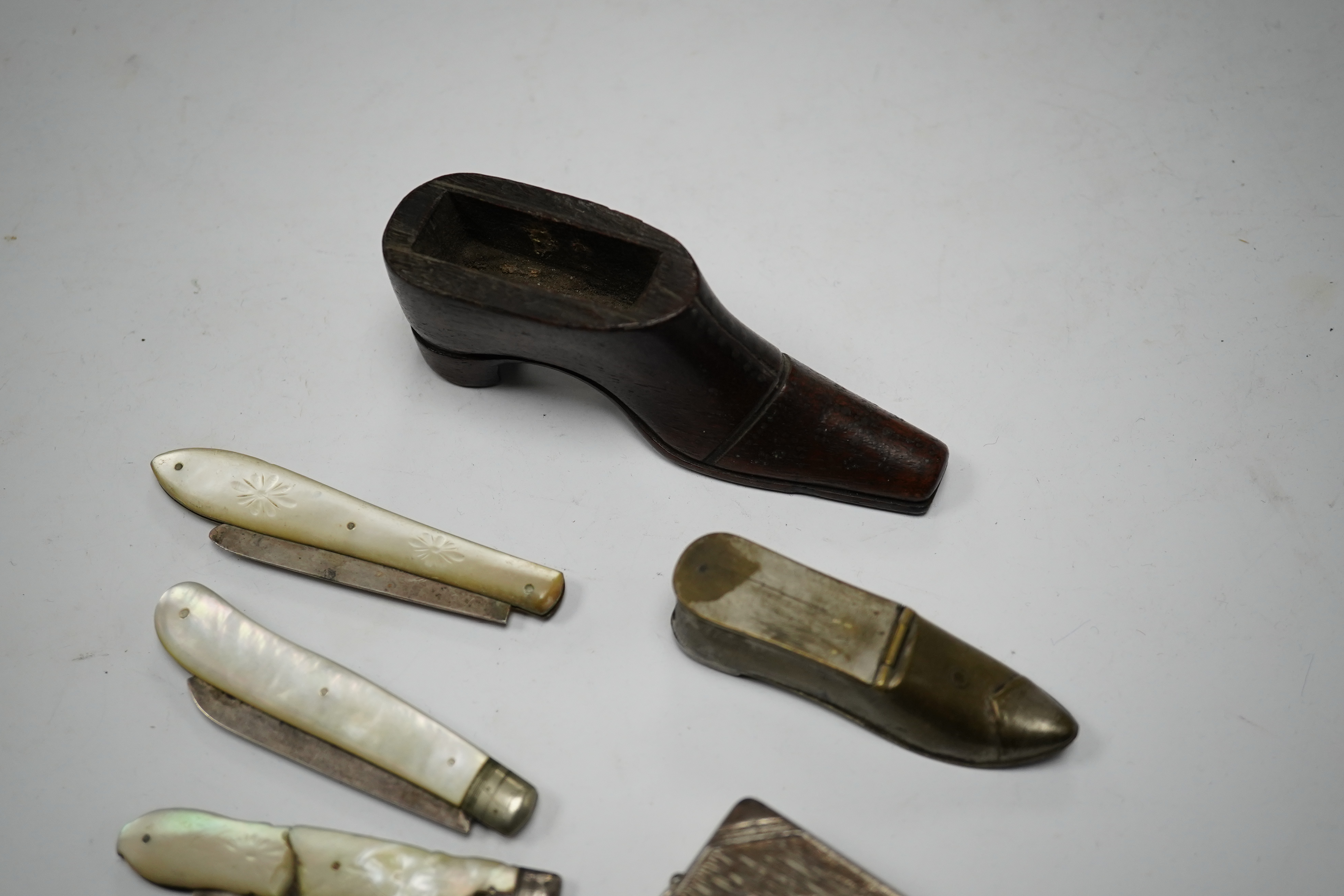 Four mother-of-pearl penknives, two vesta cases and a treen shoe, treen shoe 10cm long. Condition - fair